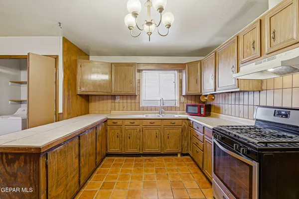 a kitchen with a stove and a sink