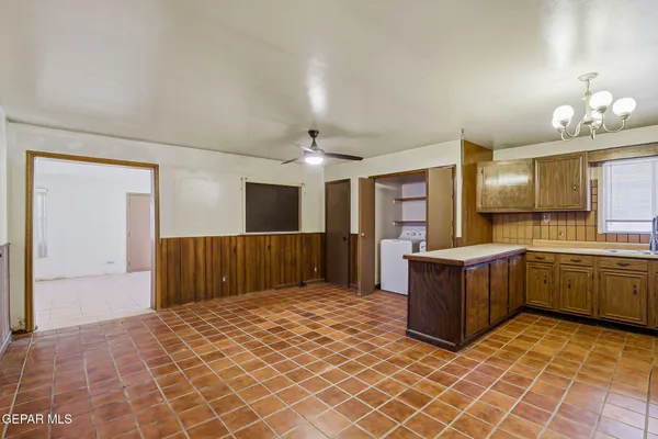 a large kitchen with a sink and cabinets