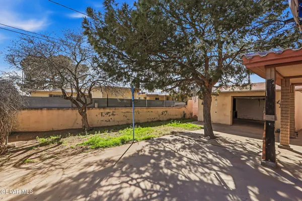 a yellow house with trees in front of it
