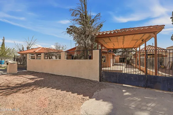 a view of a house with a wooden fence