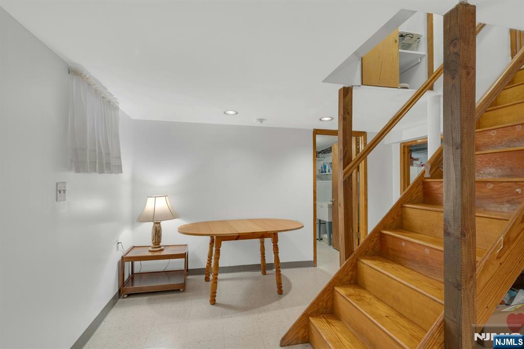 24 Cambridge Road Tenafly, NJ 07670 - Photo 26 of 31 a balcony with chairs and a potted plant on a table