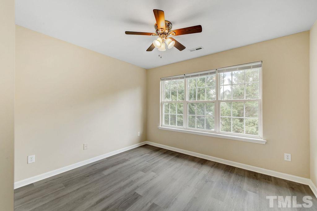 4104 Standing Rock Way Raleigh, NC 27604 - Photo 11 of 16 a view of an empty room with wooden floor and a window