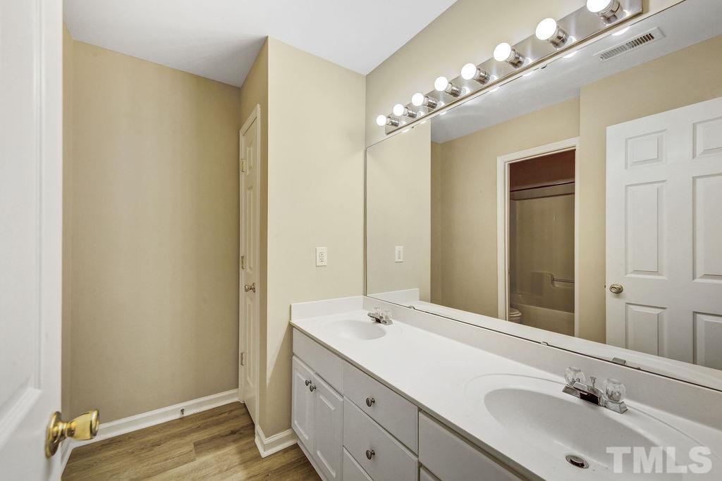 4104 Standing Rock Way Raleigh, NC 27604 - Photo 12 of 16 a bathroom with a double vanity sink and a mirror