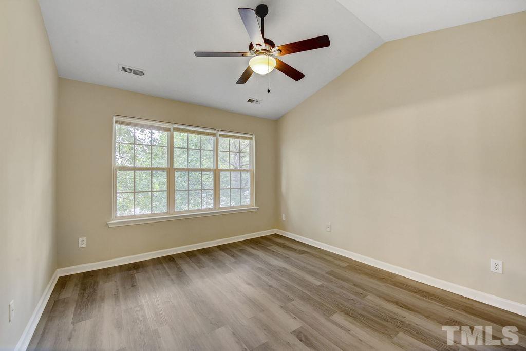 4104 Standing Rock Way Raleigh, NC 27604 - Photo 13 of 16 a view of an empty room with wooden floor and a window