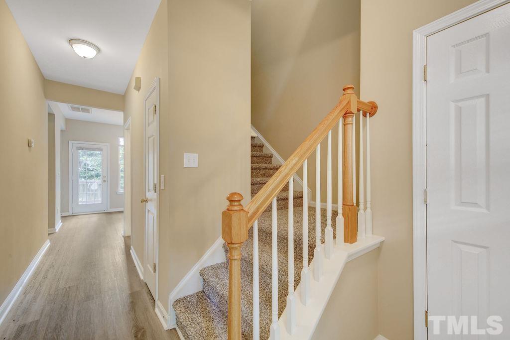 4104 Standing Rock Way Raleigh, NC 27604 - Photo 3 of 16 a view of a hallway with wooden floor and staircase