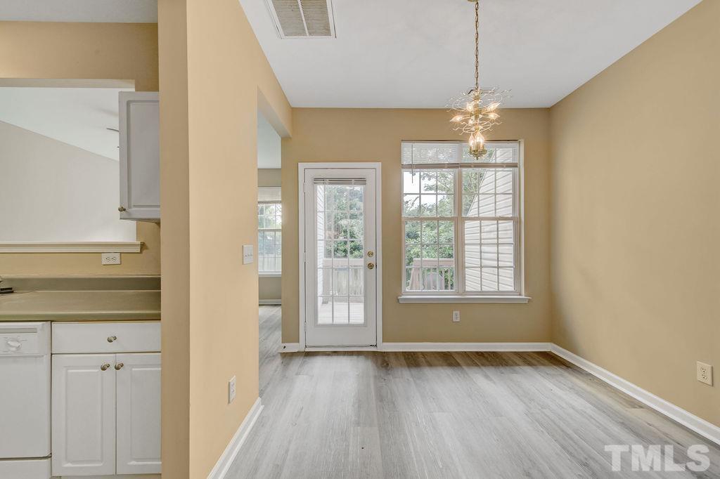 4104 Standing Rock Way Raleigh, NC 27604 - Photo 4 of 16 a view of an empty room with wooden floor and a window