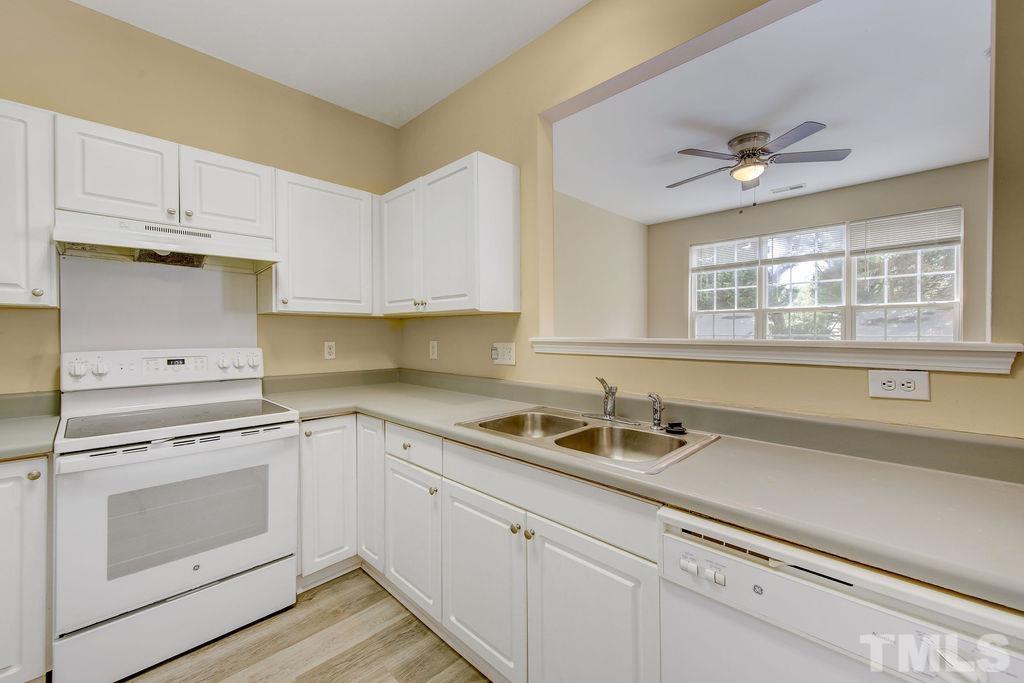 4104 Standing Rock Way Raleigh, NC 27604 - Photo 7 of 16 a kitchen with appliances cabinets and a sink