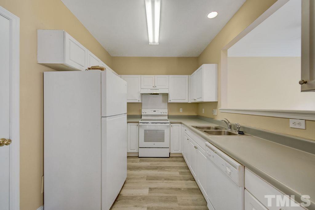 4104 Standing Rock Way Raleigh, NC 27604 - Photo 8 of 16 a kitchen with a sink a stove and refrigerator