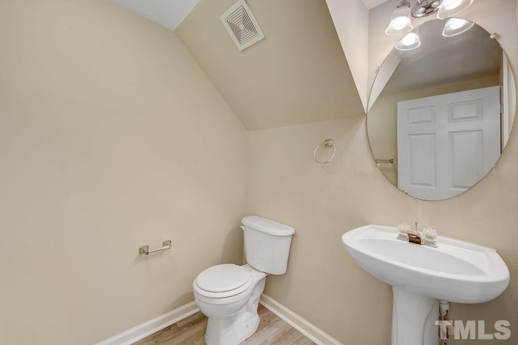4104 Standing Rock Way Raleigh, NC 27604 - Photo 9 of 16 a bathroom with a toilet sink and mirror