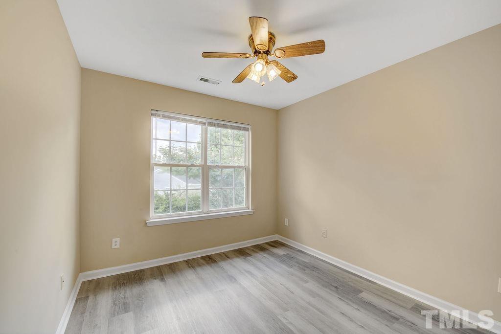 4104 Standing Rock Way Raleigh, NC 27604 - Photo 10 of 16 an empty room with wooden floor and windows