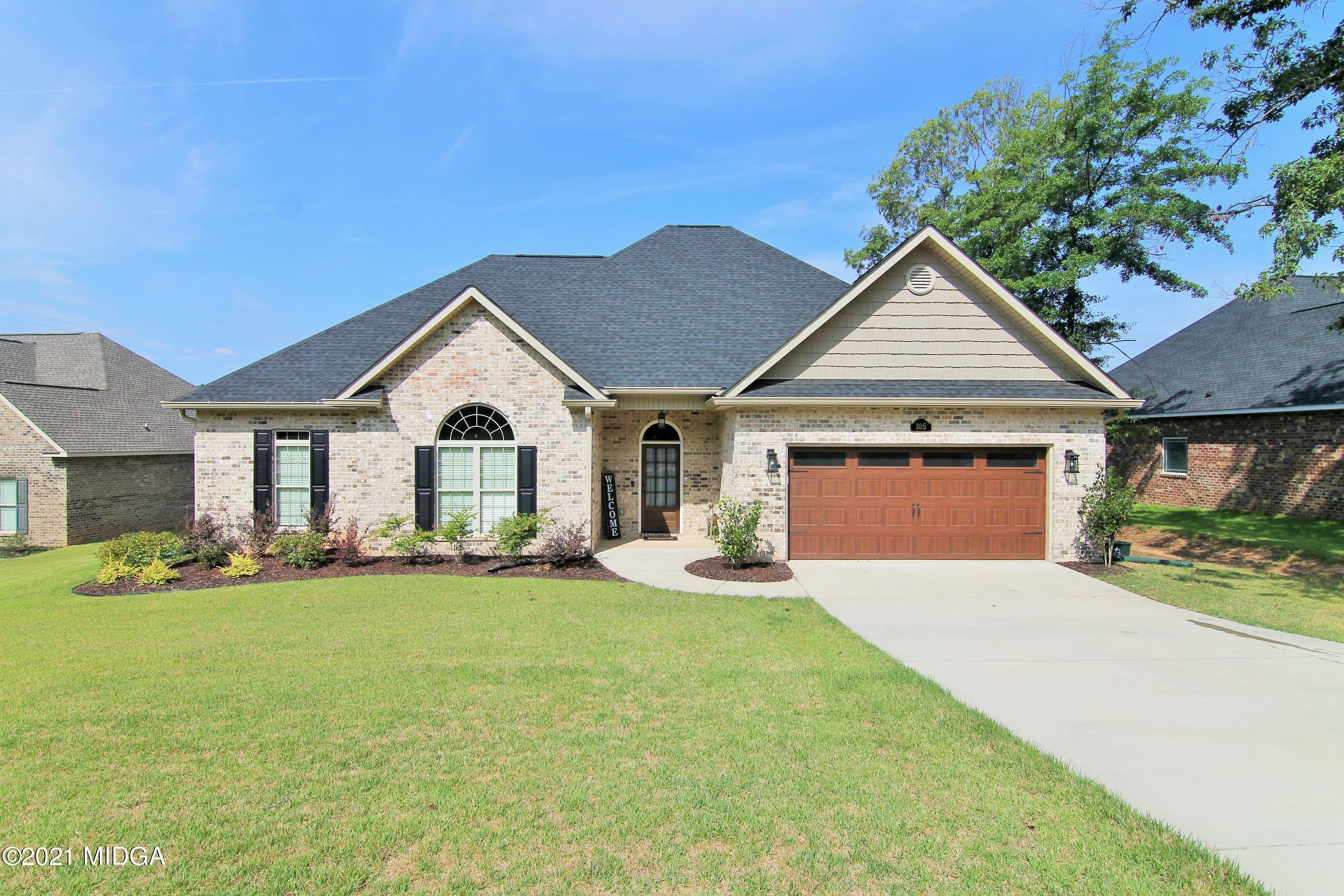 a view of a house with a yard and garage