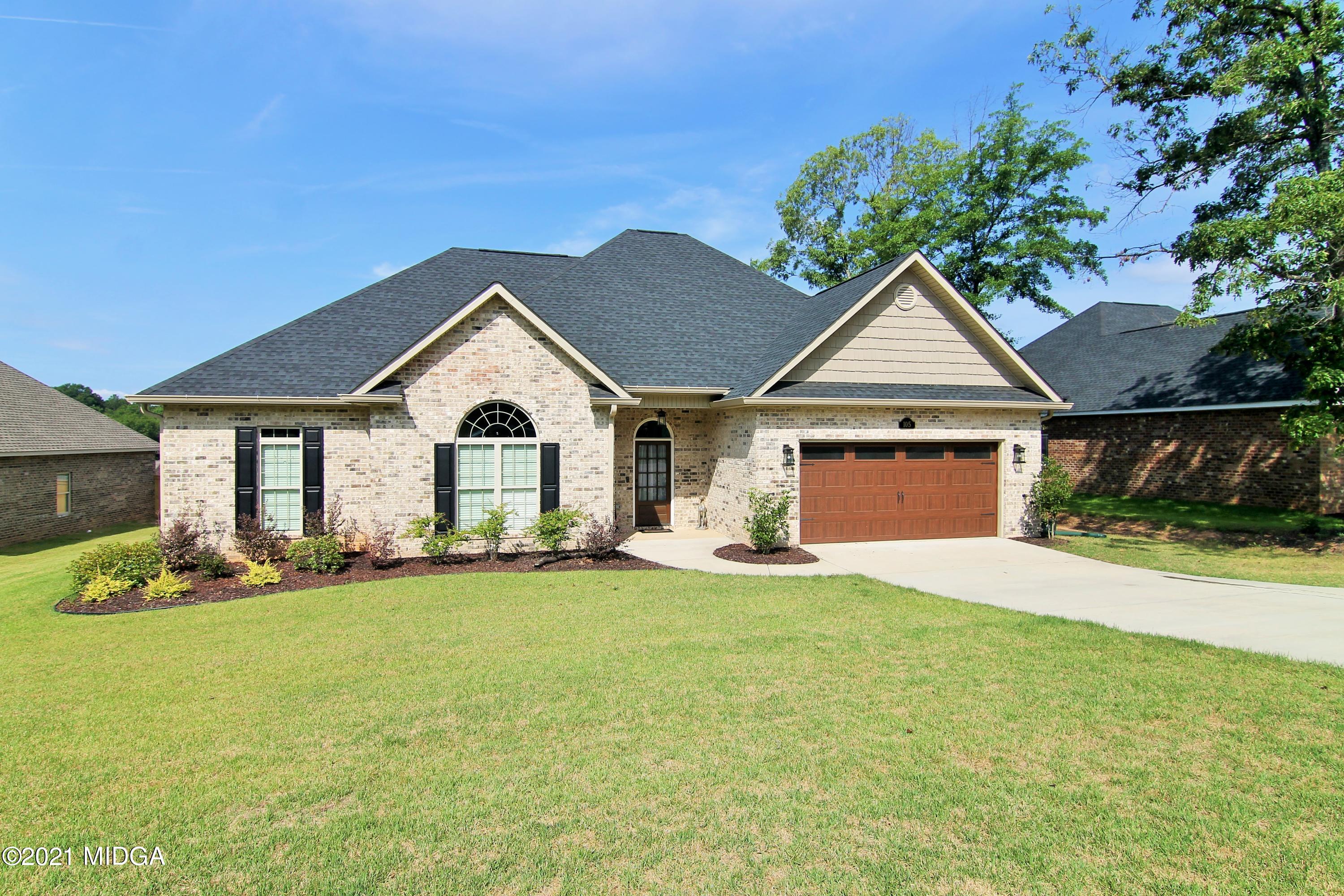 105 Timber Ridge Circle Byron, GA 31008 - Photo 2 of 28 a front view of a house with a yard and garage