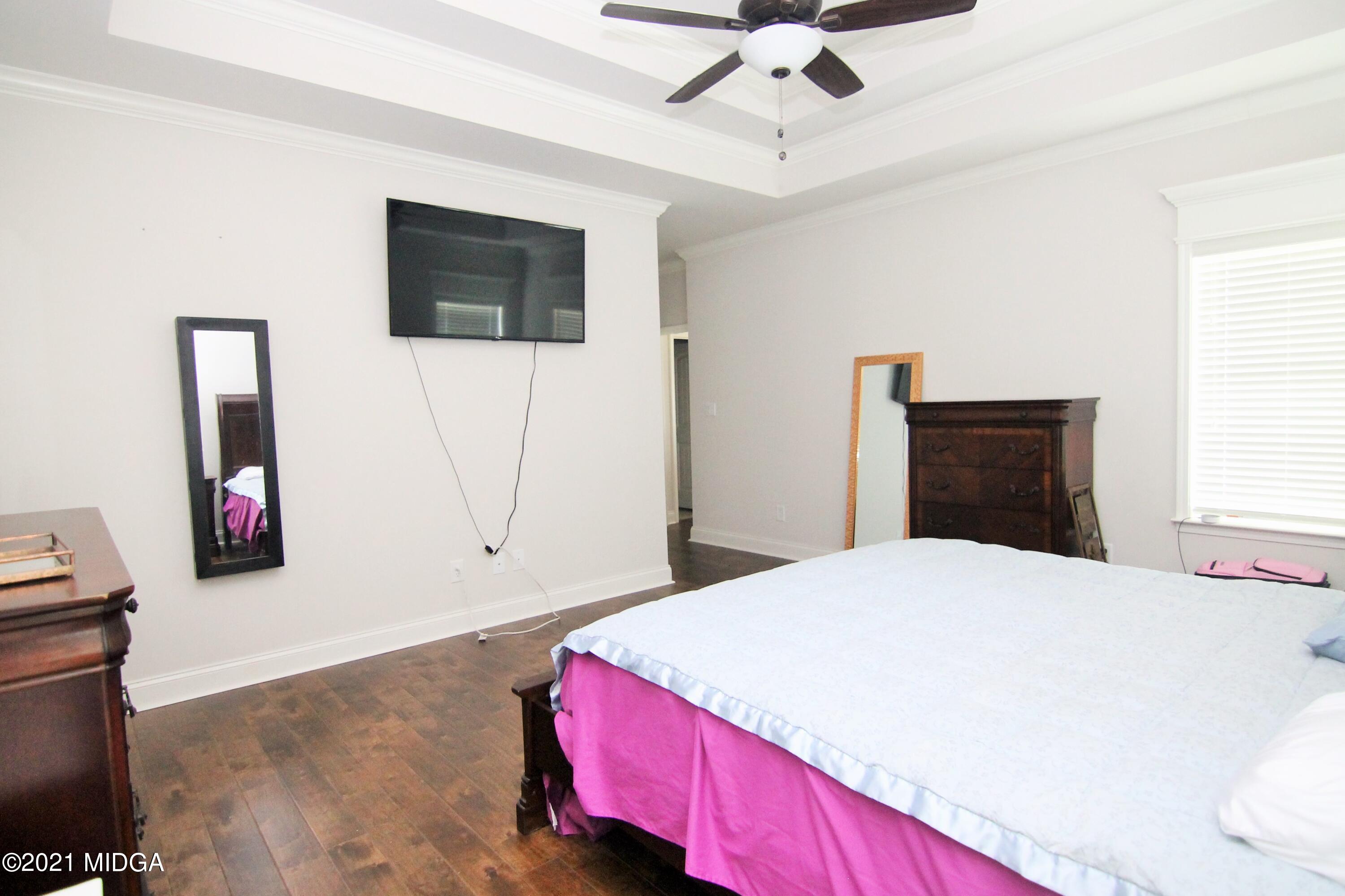 105 Timber Ridge Circle Byron, GA 31008 - Photo 15 of 28 a bedroom with a bed and a flat screen tv