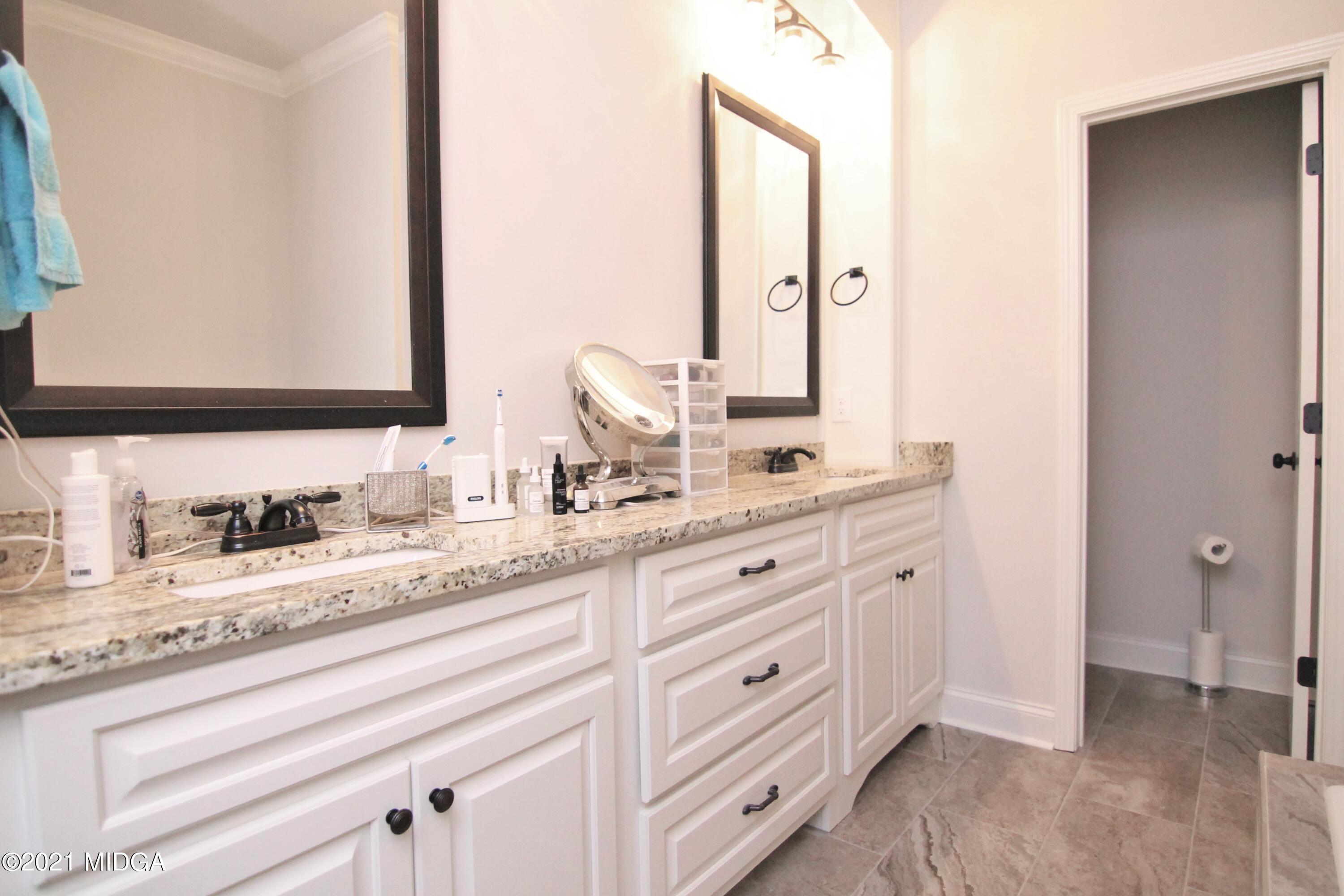 105 Timber Ridge Circle Byron, GA 31008 - Photo 16 of 28 a bathroom with double sink and a mirror