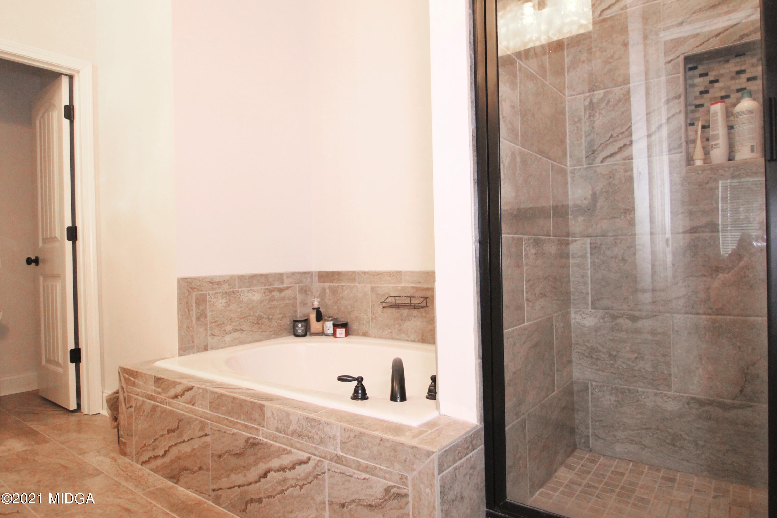 105 Timber Ridge Circle Byron, GA 31008 - Photo 17 of 28 a bathroom with a tub and shower