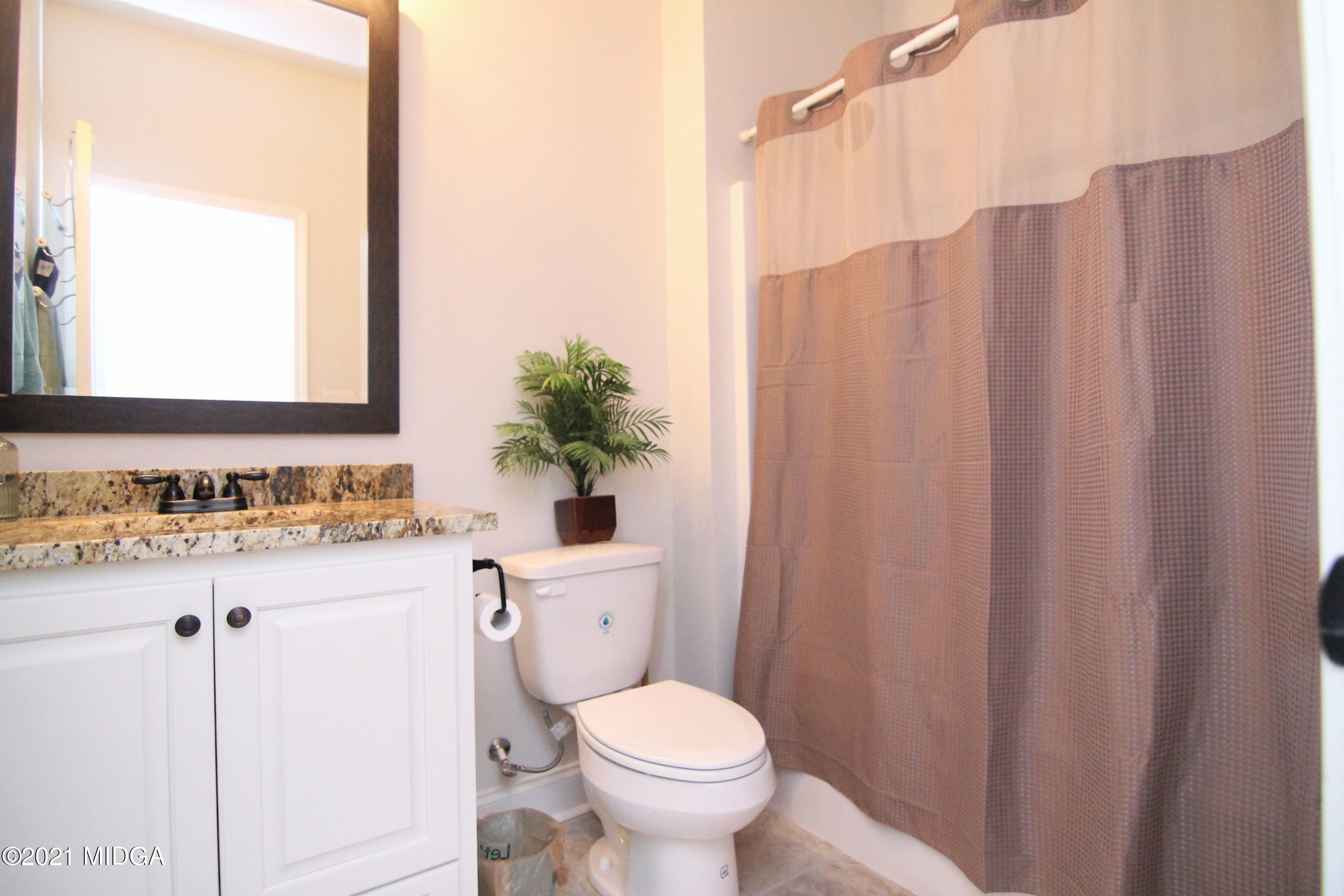 105 Timber Ridge Circle Byron, GA 31008 - Photo 21 of 28 a bathroom with a sink a toilet and a mirror
