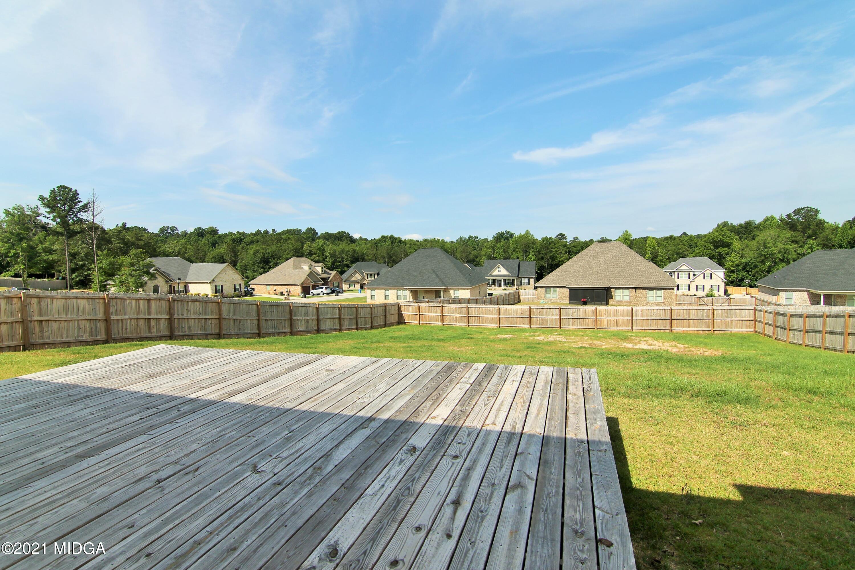 105 Timber Ridge Circle Byron, GA 31008 - Photo 25 of 28 a view of swimming pool with lawn chairs and large trees
