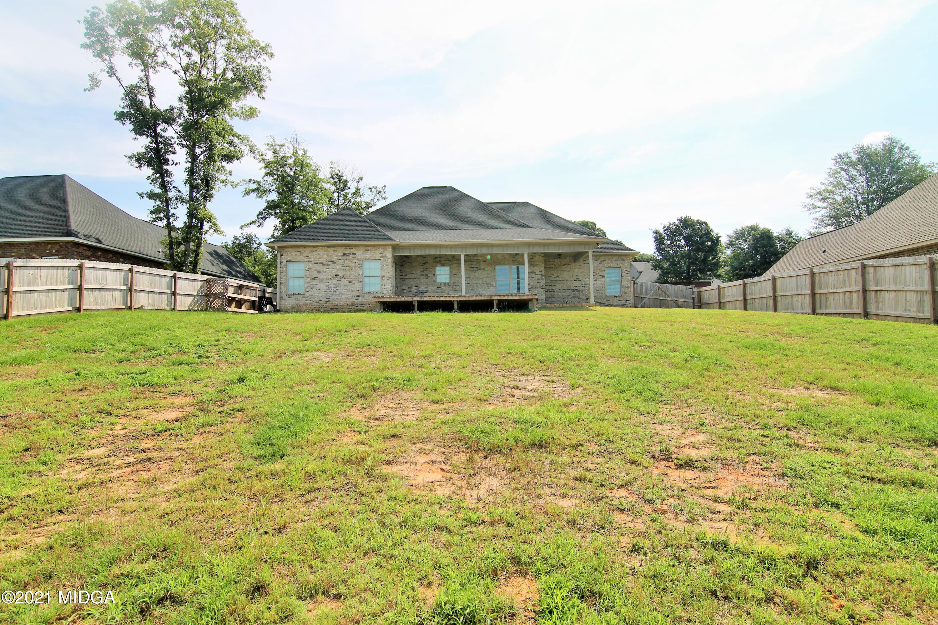 105 Timber Ridge Circle Byron, GA 31008 - Photo 26 of 28 a large house with a big yard and large trees