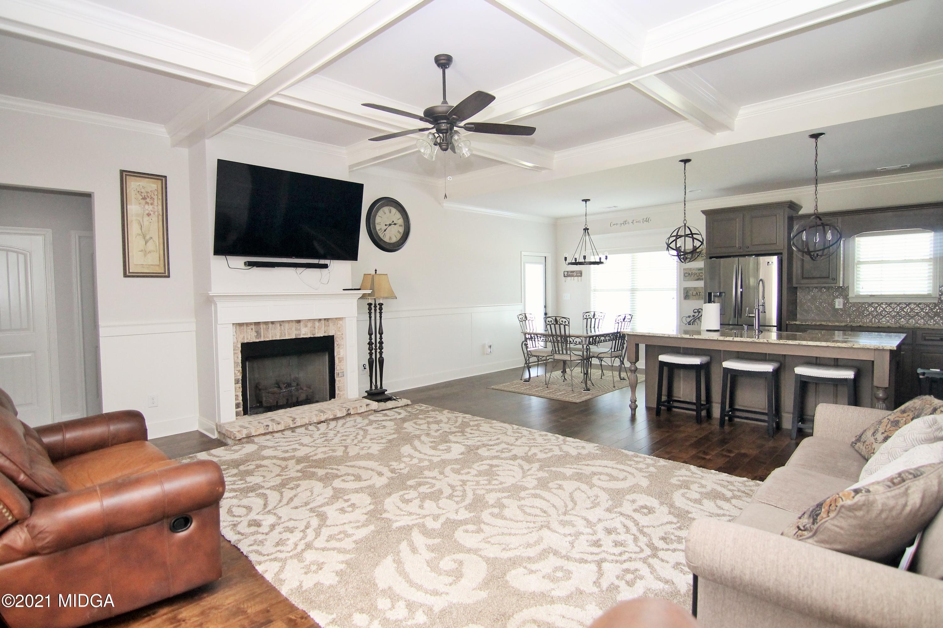 105 Timber Ridge Circle Byron, GA 31008 - Photo 4 of 28 a living room with furniture a flat screen tv and a fireplace