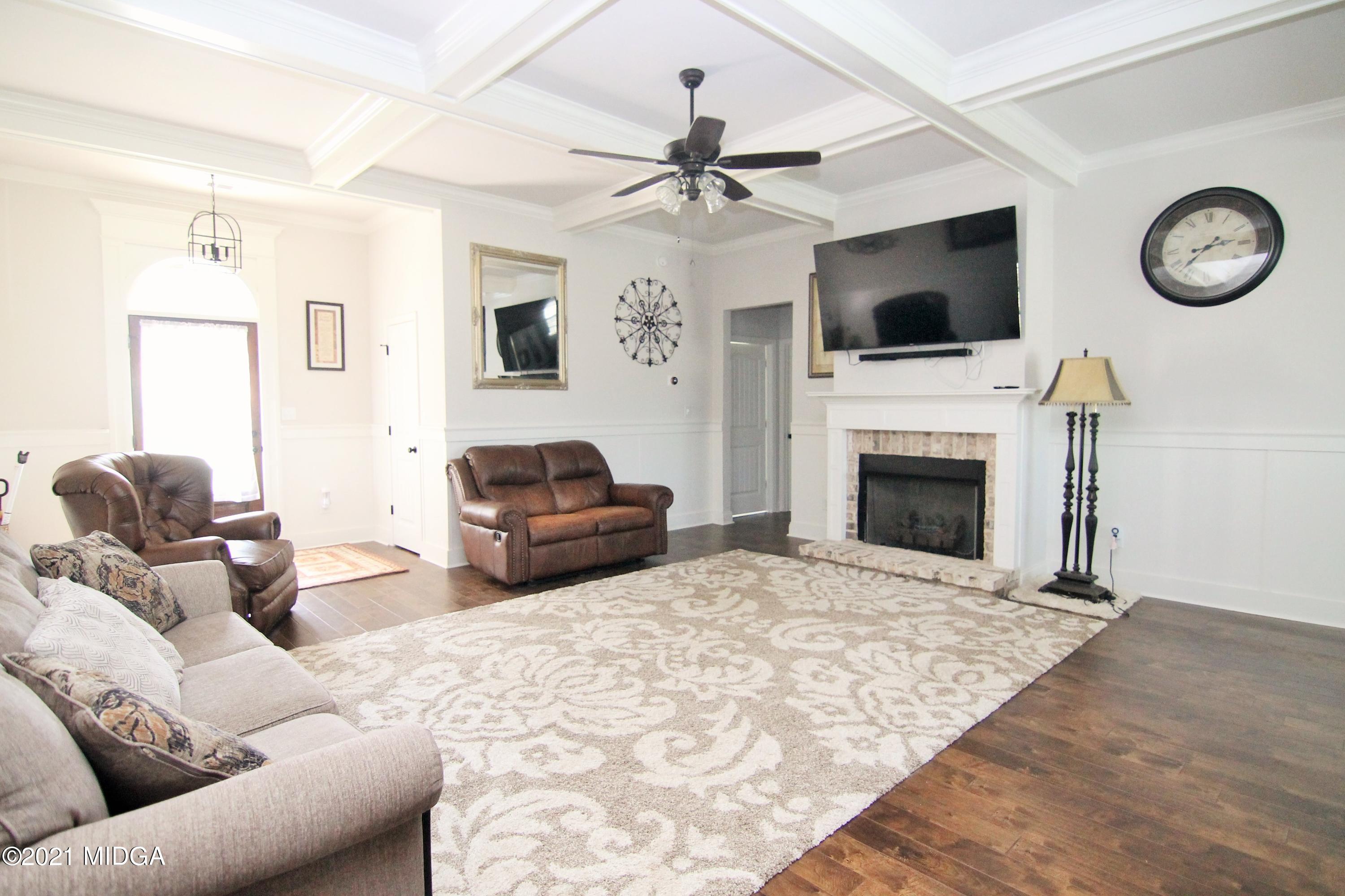 105 Timber Ridge Circle Byron, GA 31008 - Photo 6 of 28 a living room with furniture a fireplace and a flat screen tv
