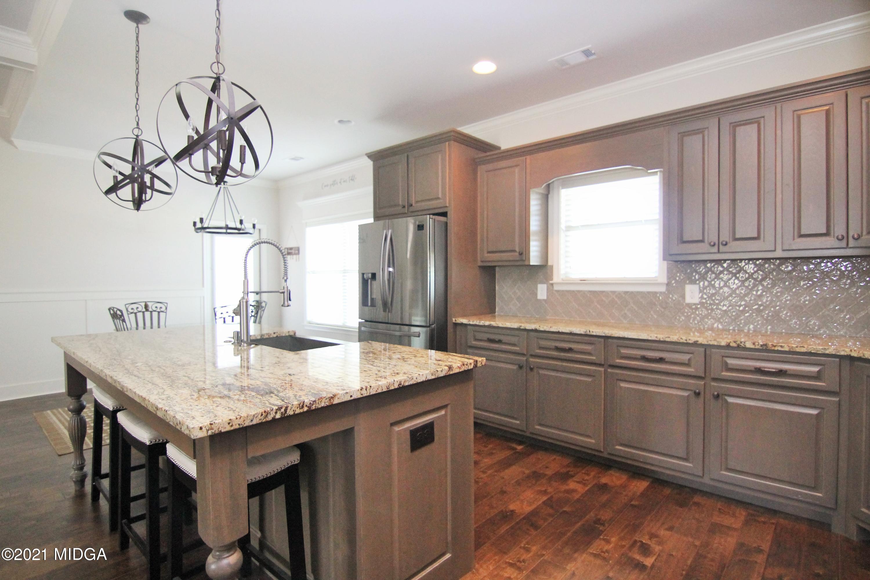 105 Timber Ridge Circle Byron, GA 31008 - Photo 10 of 28 a kitchen with stainless steel appliances granite countertop a sink stove and refrigerator