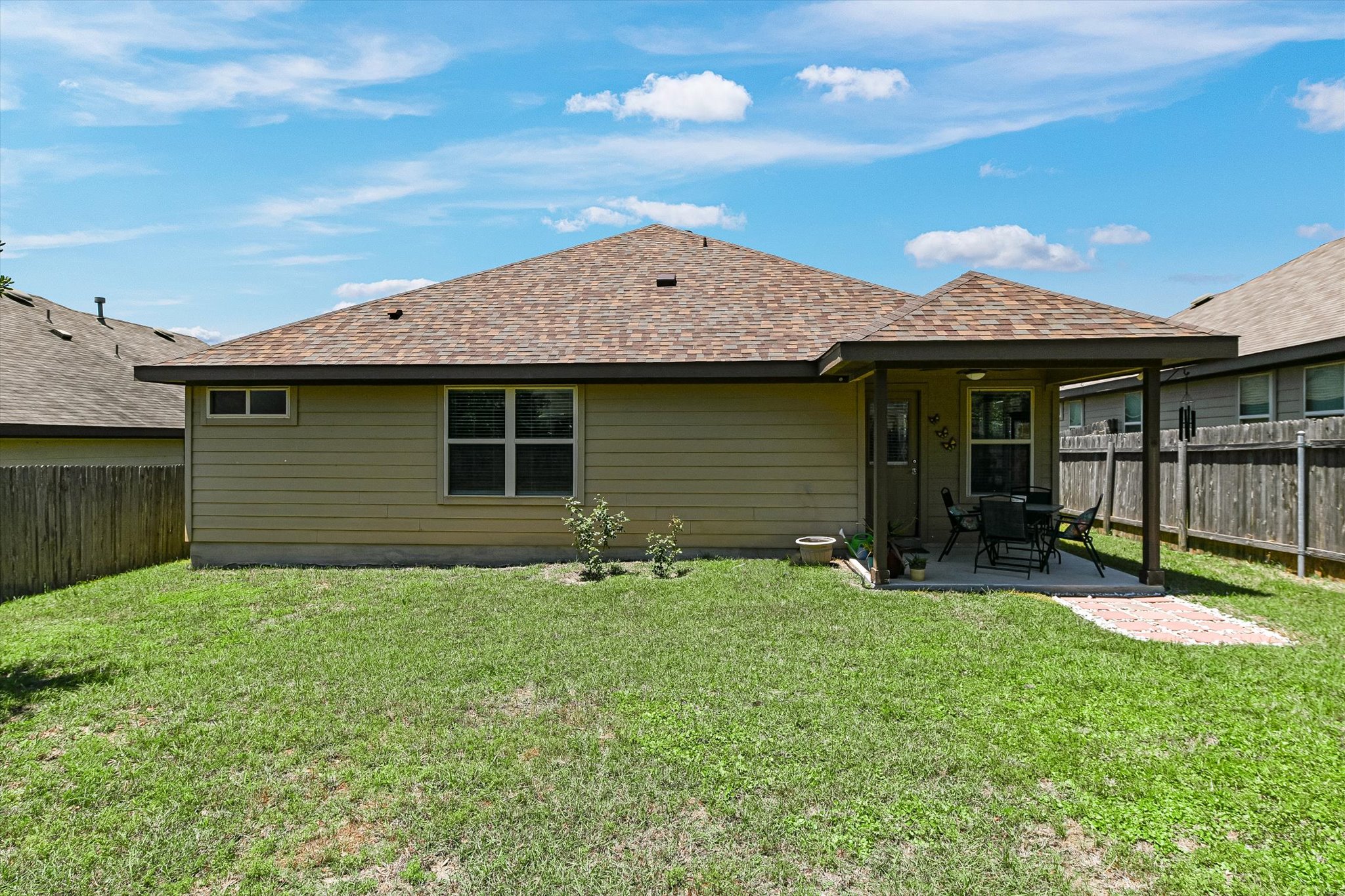 536 Dragon Ridge Road Buda, TX 78610 - Photo 19 of 20 Spacious backyard featuring a covered patio, concrete slab, and privacy fencing