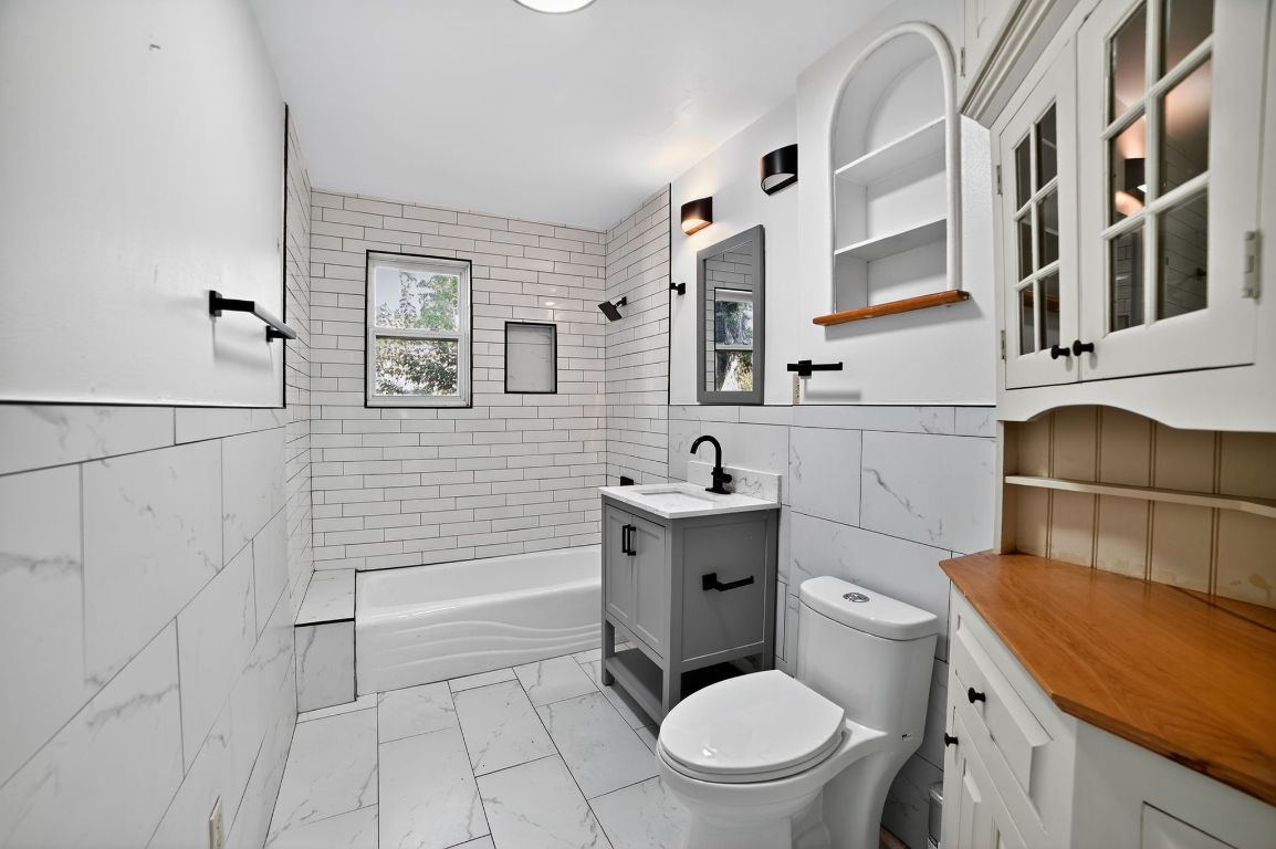 2003 Griswold Lane, Unit A Austin, TX 78703 - Photo 20 of 21 a bathroom with a sink a toilet and shower
