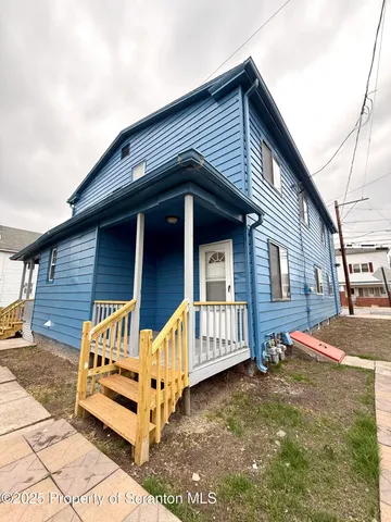 a front view of a house with wooden fence
