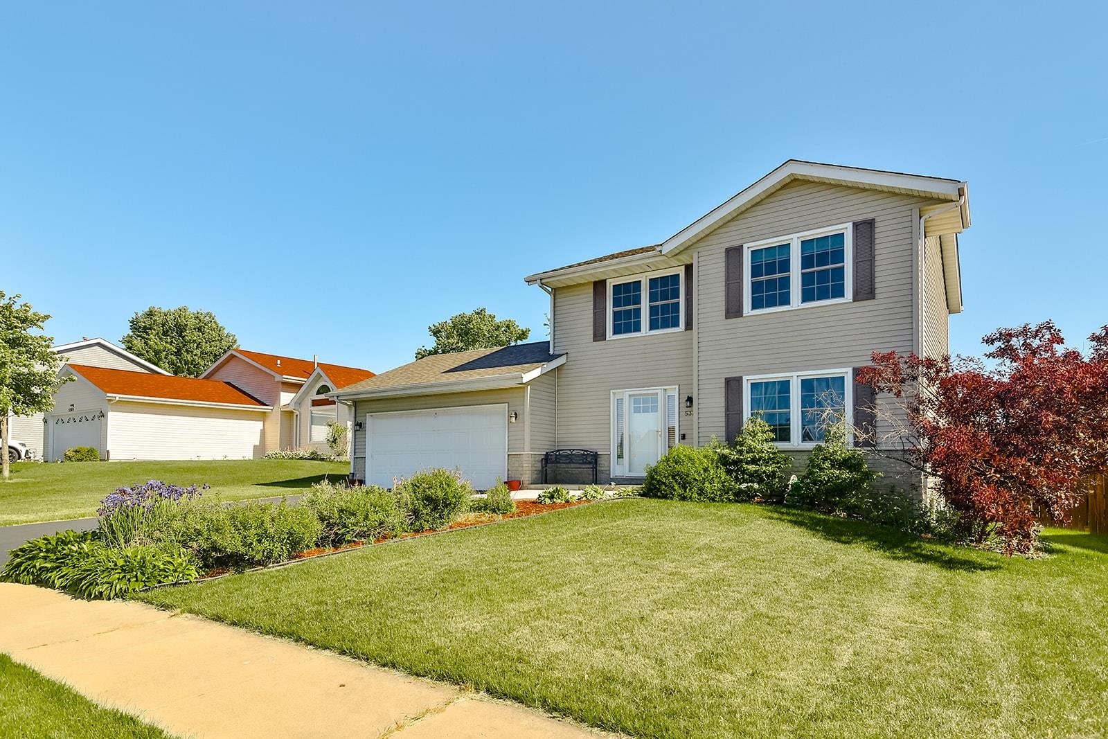 5377 Torque Road Loves Park, IL 61111 - Photo 1 of 27 a front view of a house with garden