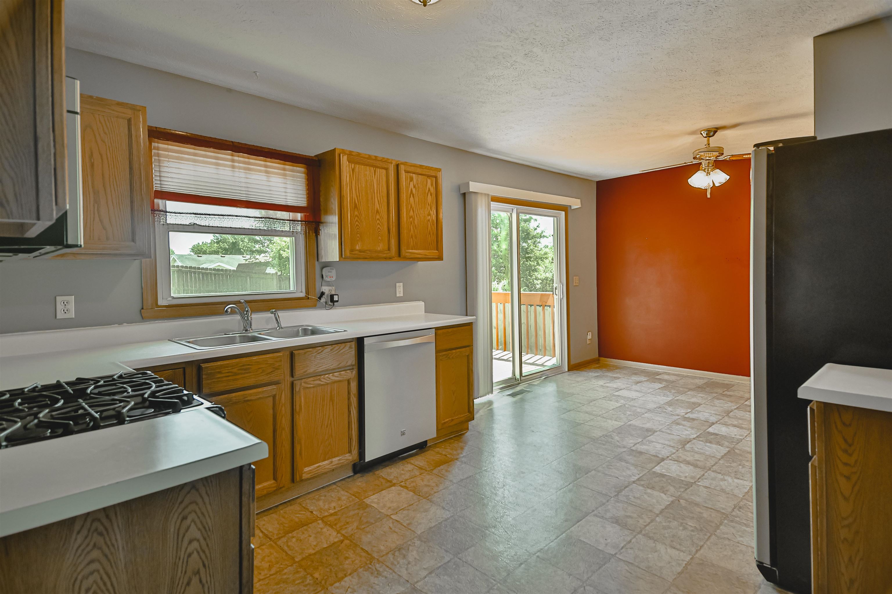 5377 Torque Road Loves Park, IL 61111 - Photo 8 of 27 a kitchen with stainless steel appliances granite countertop a sink stove and refrigerator