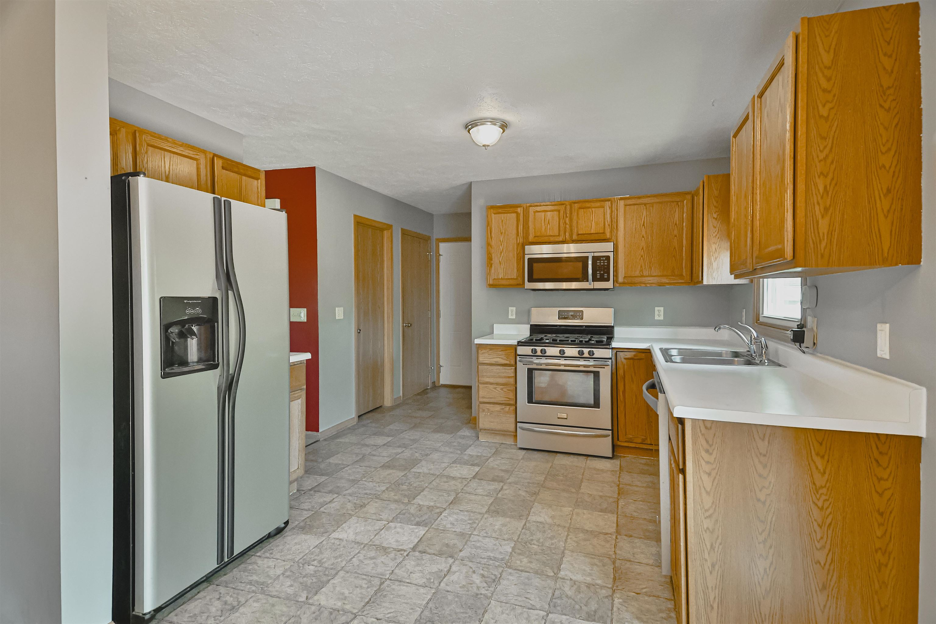 5377 Torque Road Loves Park, IL 61111 - Photo 9 of 27 a kitchen with stainless steel appliances granite countertop a refrigerator stove and sink