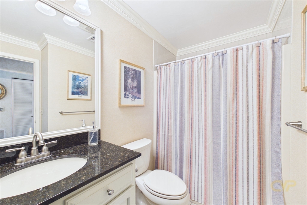 700 Shore Drive, Unit 509 Fall River, MA 02721 - Photo 18 of 25 a bathroom with a granite countertop sink toilet and mirror