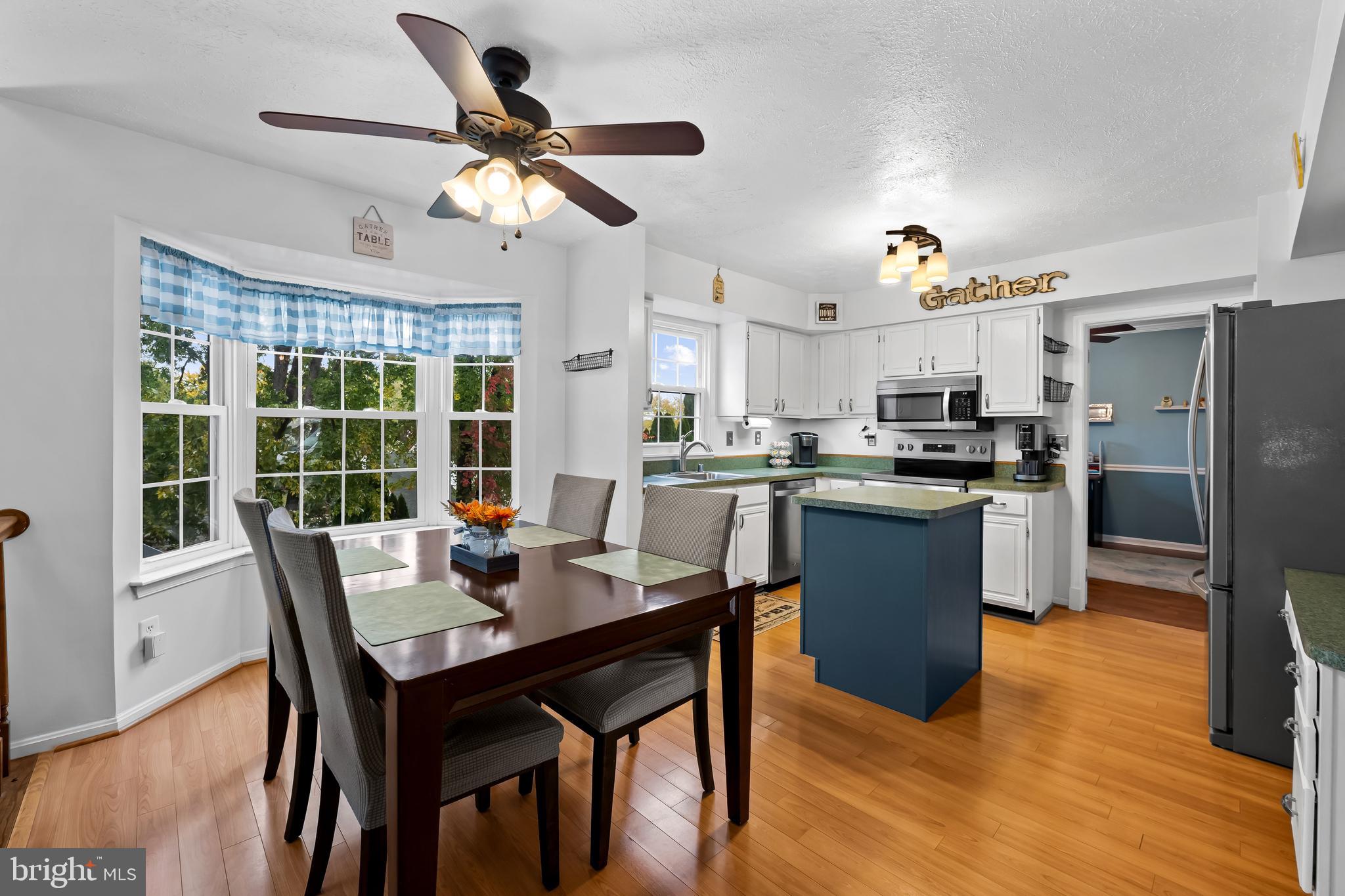 3746 Proctor Lane Nottingham, MD 21236 - Photo 16 of 36 a kitchen with a dining table and chairs