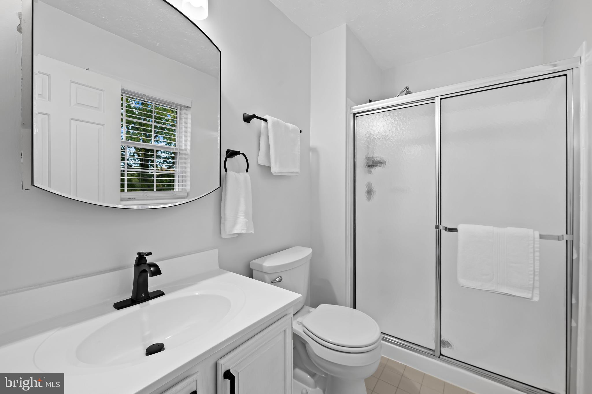 3746 Proctor Lane Nottingham, MD 21236 - Photo 25 of 36 a bathroom with a sink a toilet and shower