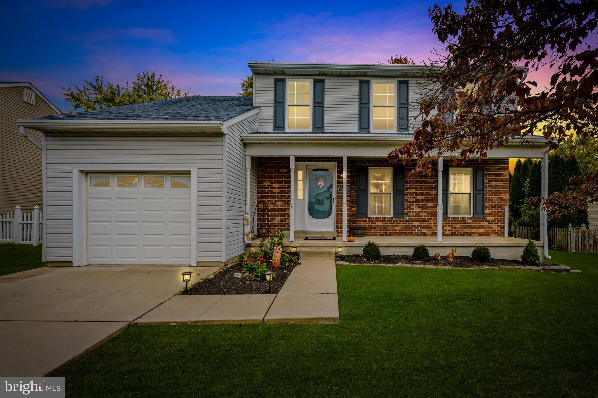 3746 Proctor Lane Nottingham, MD 21236 - Photo 35 of 36 a front view of a house with a yard and garage