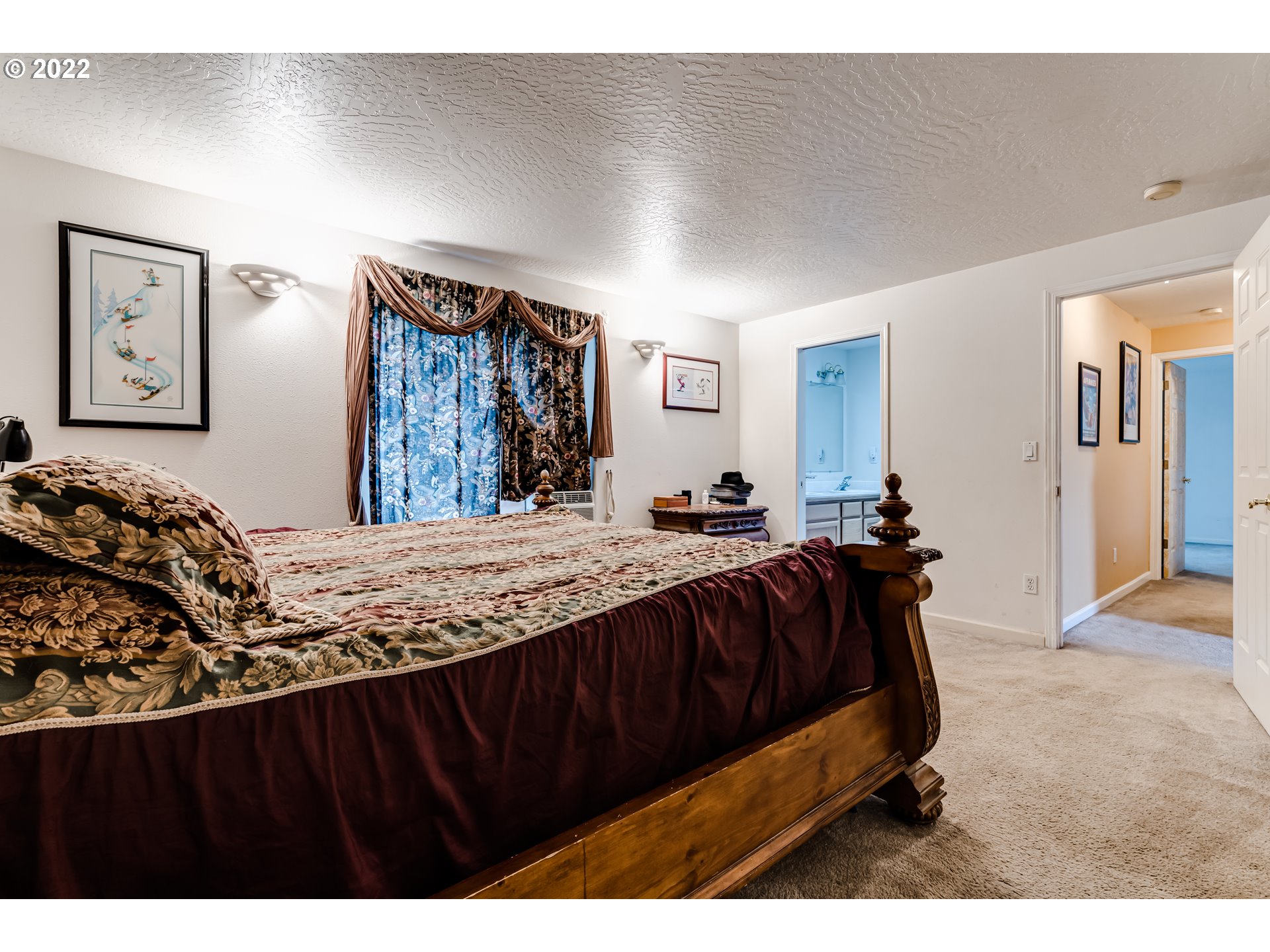 823 South 46th Street Springfield, OR 97478 - Photo 20 of 32 a spacious bedroom with a bed and painting on the wall