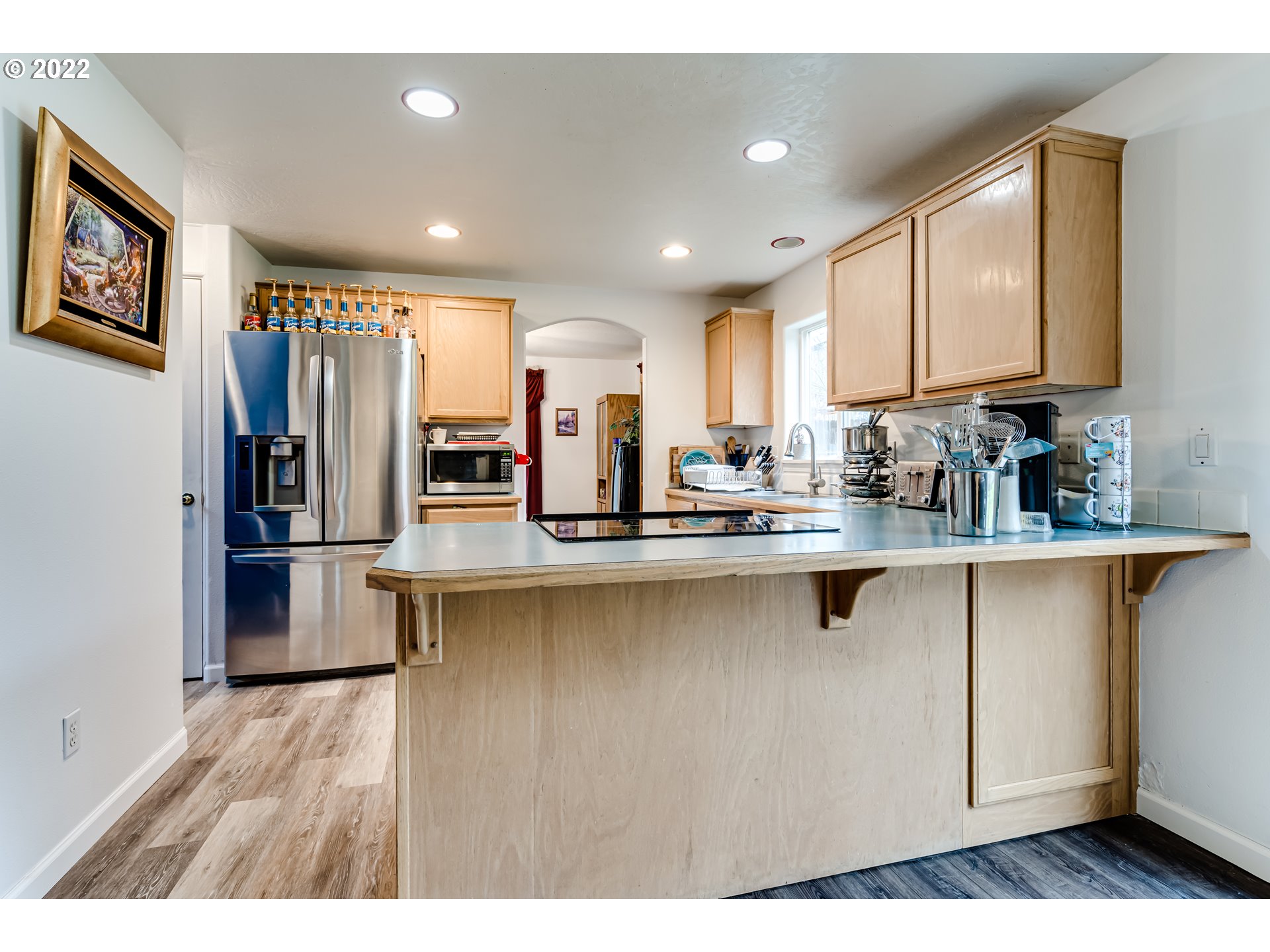 823 South 46th Street Springfield, OR 97478 - Photo 9 of 32 a kitchen with stainless steel appliances granite countertop a refrigerator a sink dishwasher a stove with wooden cabinets and floor