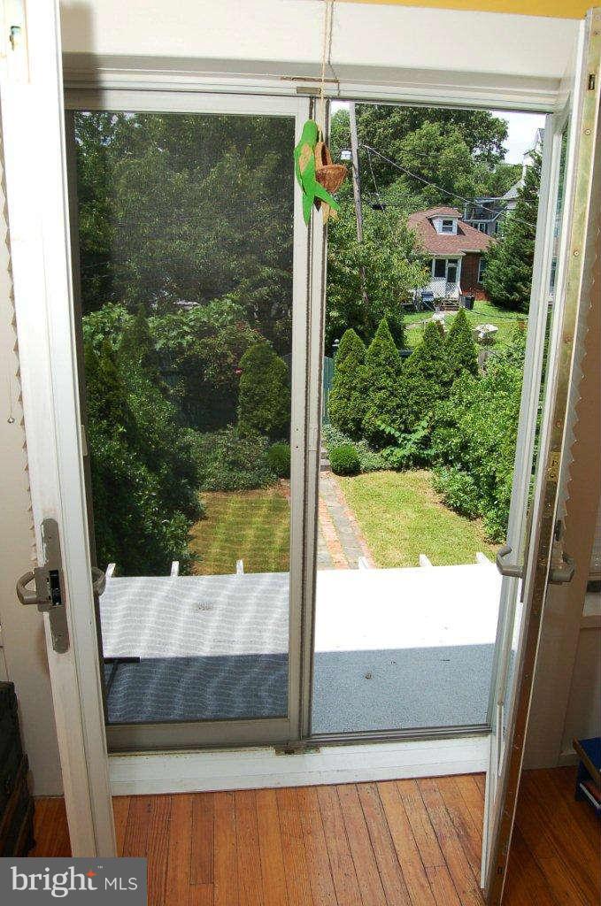 4616 Keswick Road Baltimore, MD 21210 - Photo 14 of 18 a view of a glass door with a tree