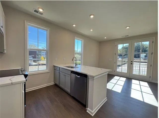 a kitchen with a sink stove and cabinets