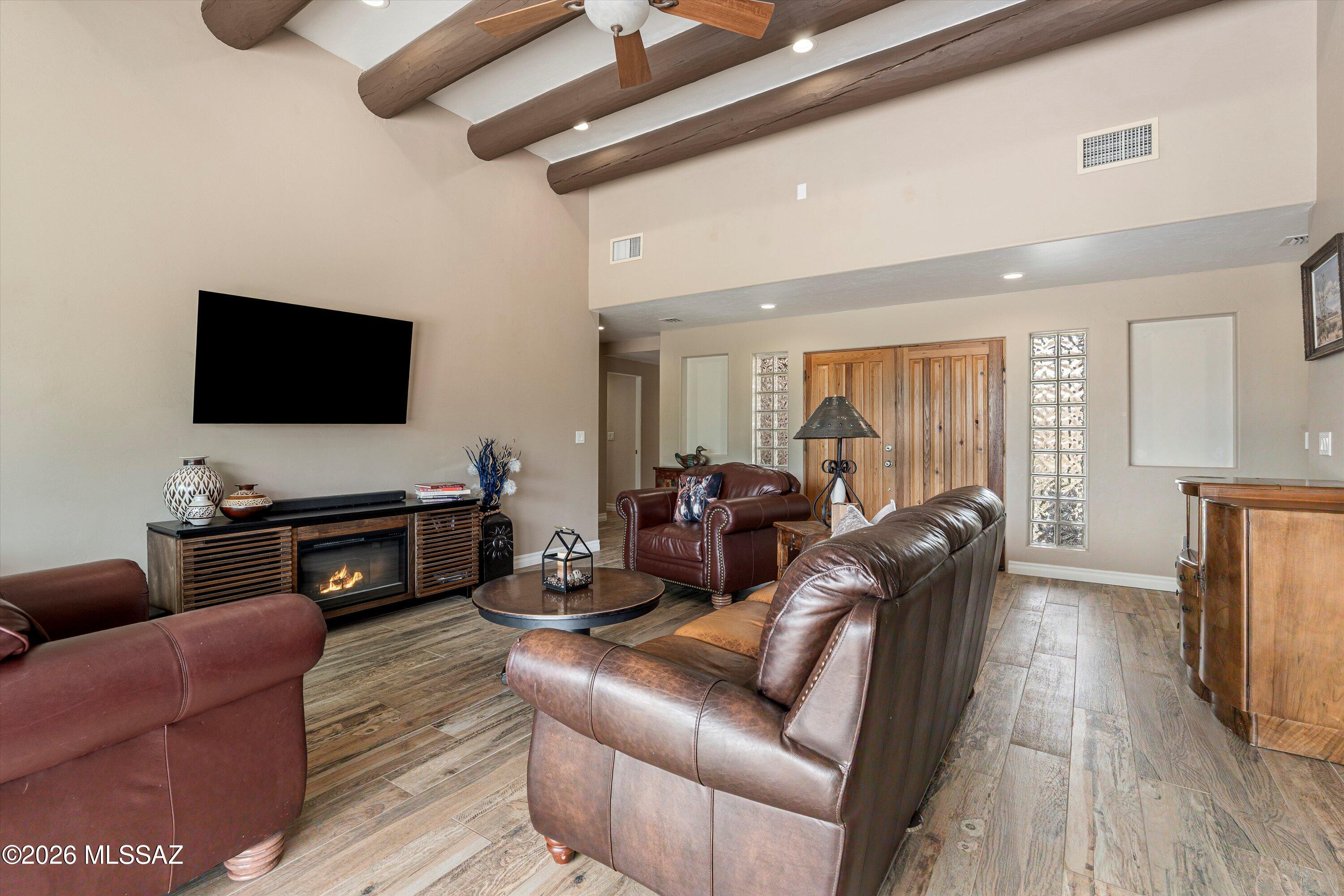 4760 East Wagon Train Road Tucson, AZ 85739 - Photo 12 of 38 a living room with furniture and a flat screen tv