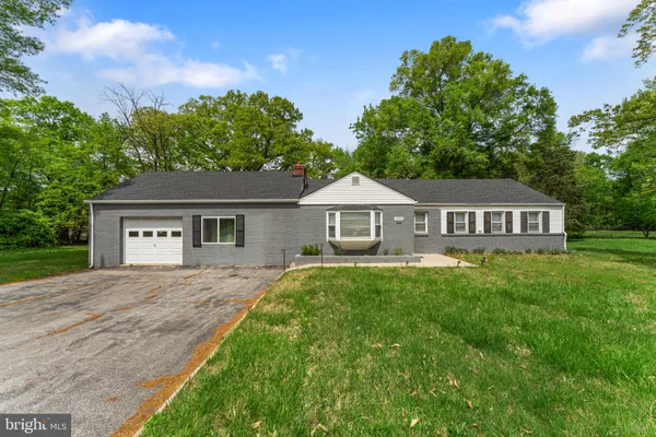 a front view of a house with yard and green space