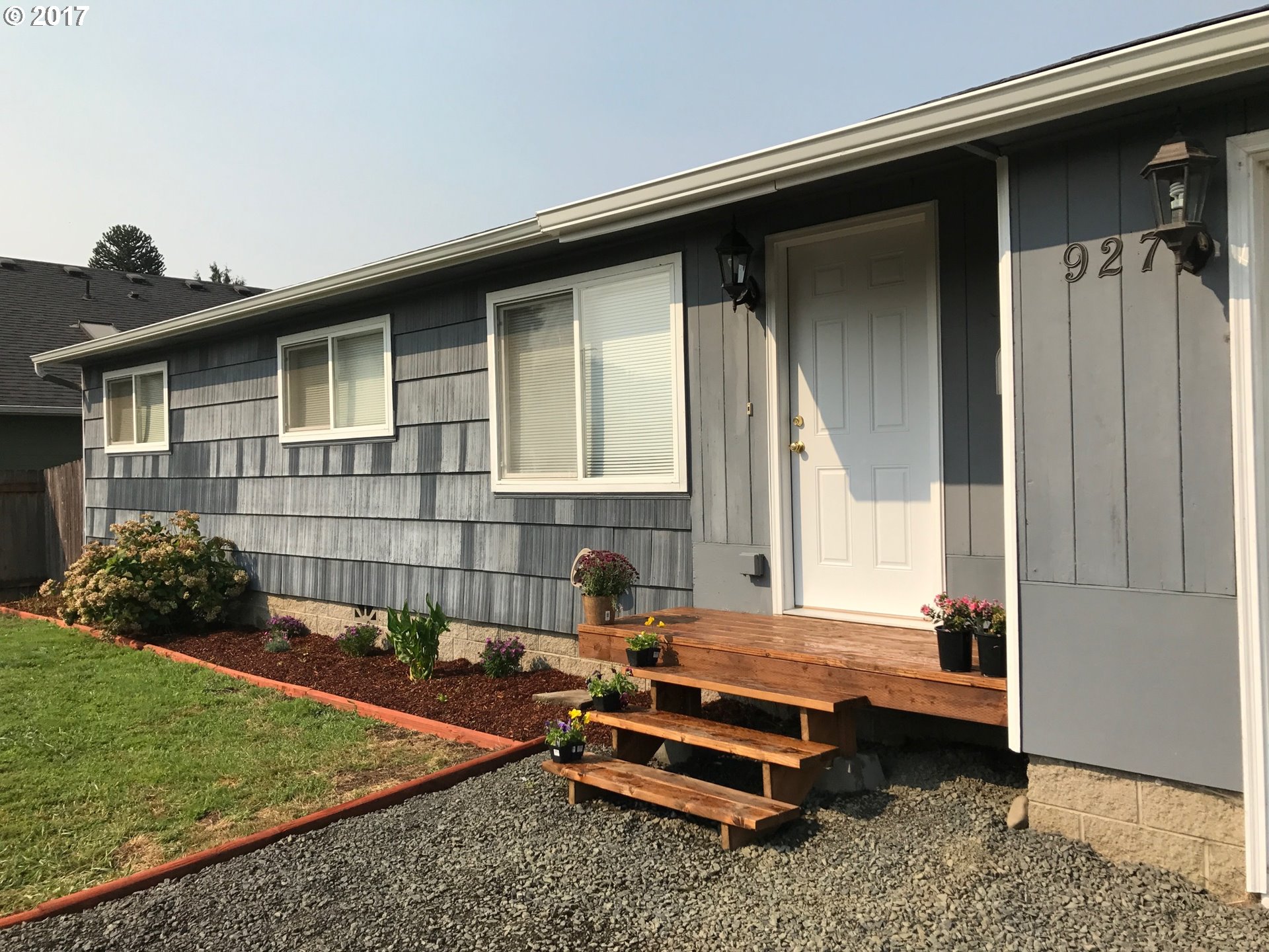 927 54th Place Springfield, OR 97478 - Photo 3 of 26 a backyard of a house with barbeque oven table and chairs