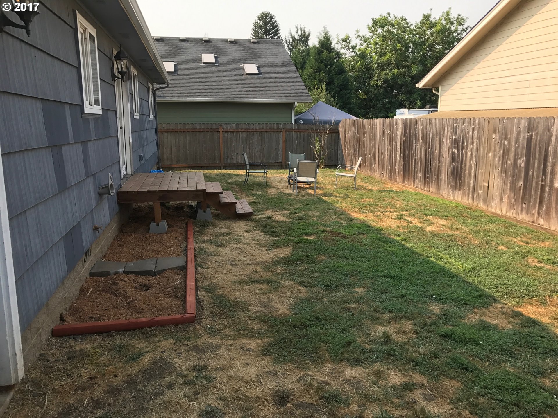 927 54th Place Springfield, OR 97478 - Photo 7 of 26 a backyard of a house with table and chairs
