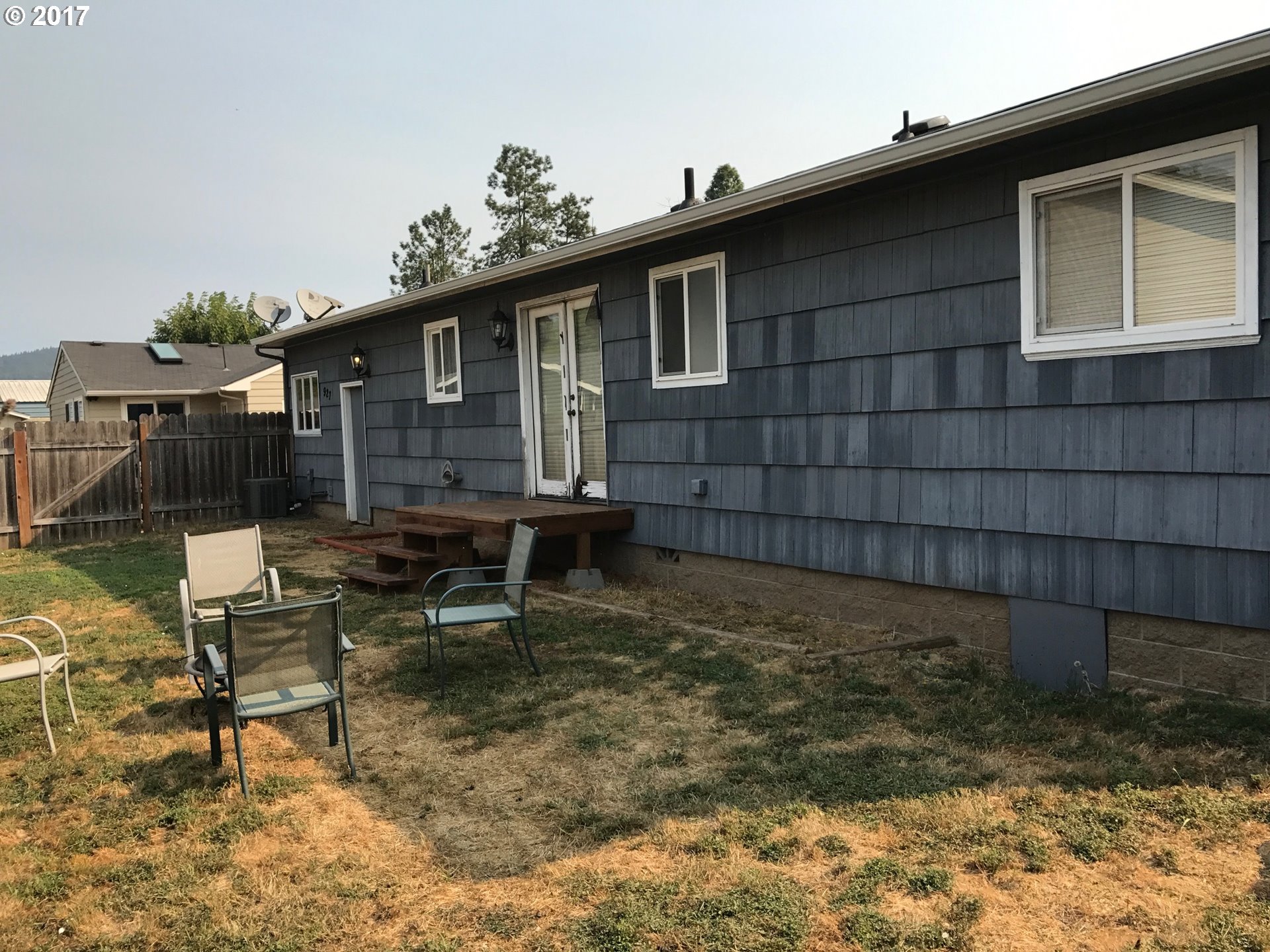 927 54th Place Springfield, OR 97478 - Photo 8 of 26 a backyard of a house with table and chairs