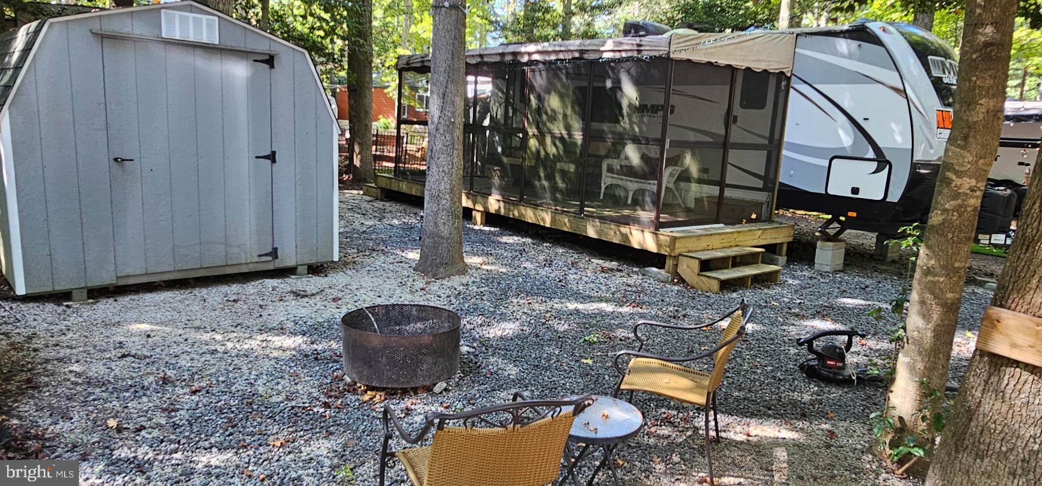 669 Route 9 Rte Cape, Unit 439 Cape May, NJ 08204 - Photo 18 of 18 a view of a backyard with chairs and a fire pit