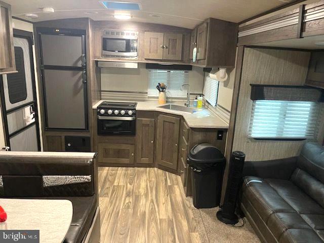 669 Route 9 Rte Cape, Unit 439 Cape May, NJ 08204 - Photo 2 of 18 a kitchen with stainless steel appliances granite countertop a refrigerator a stove and a sink
