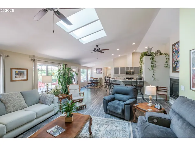 a living room with furniture and a view of kitchen
