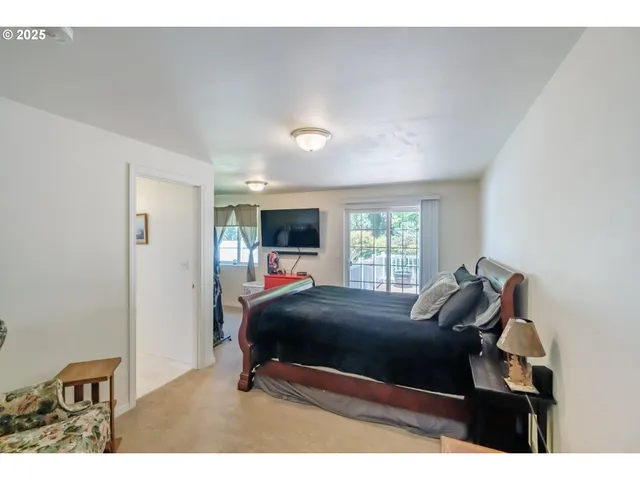 a bed room with a bed and a chair