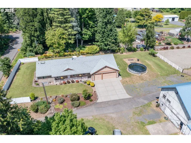 an aerial view of a house with yard