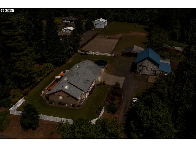 an aerial view of a house with a yard